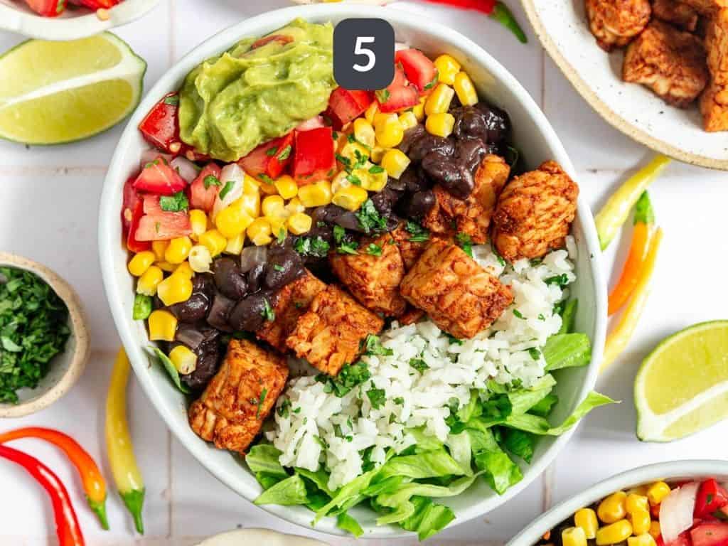 Tempeh burrito bowls step 5 - assemble the bowls.
