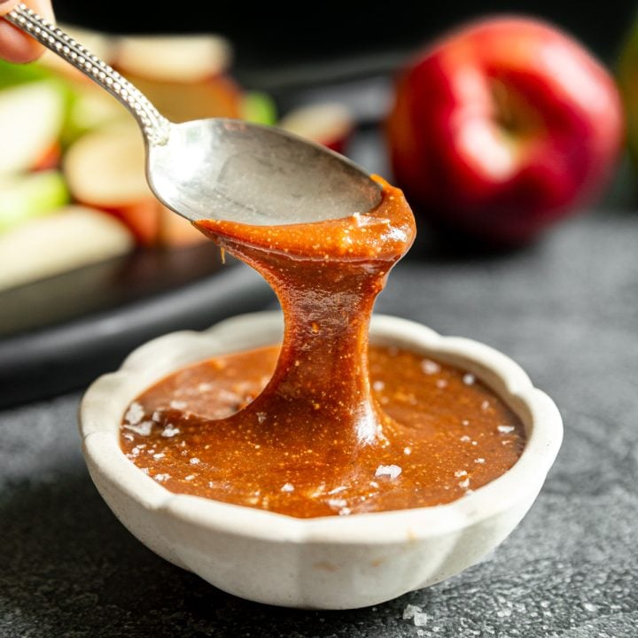 A spoon scooping a drizzle of vegan caramel.