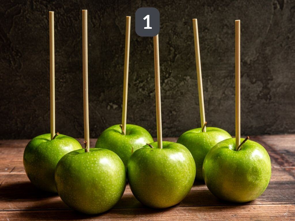 Vegan caramel apples step 1 - skewer the apples.