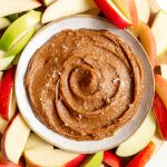 A tray of apples and a bowl of Vegan Date Caramel Sauce.