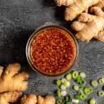 A jar of WFPB teriyaki sauce with scallions and ginger.