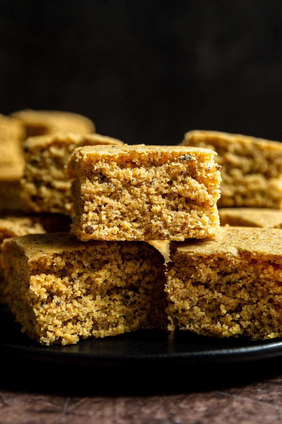 A plate with three squares of vegan cornbread.