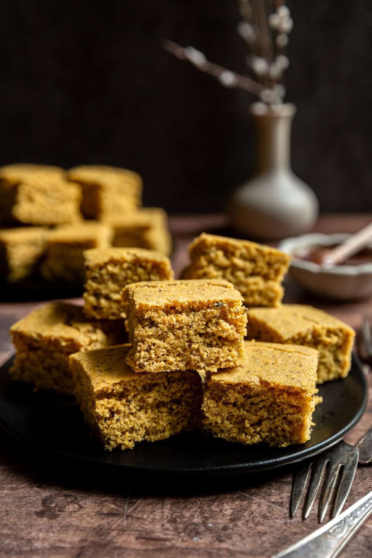 A plate filled with squares of vegan cornbread.