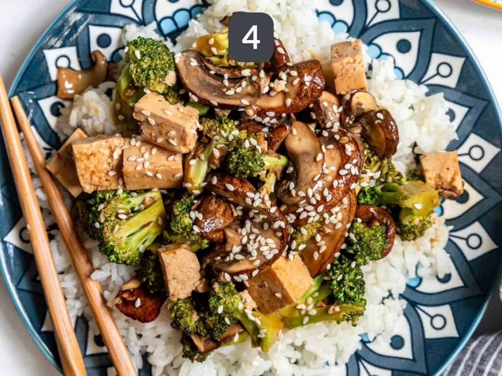 Tofu Broccoli Mushroom Stir Fry Step 4 - serve over rice, with sesame seeds.