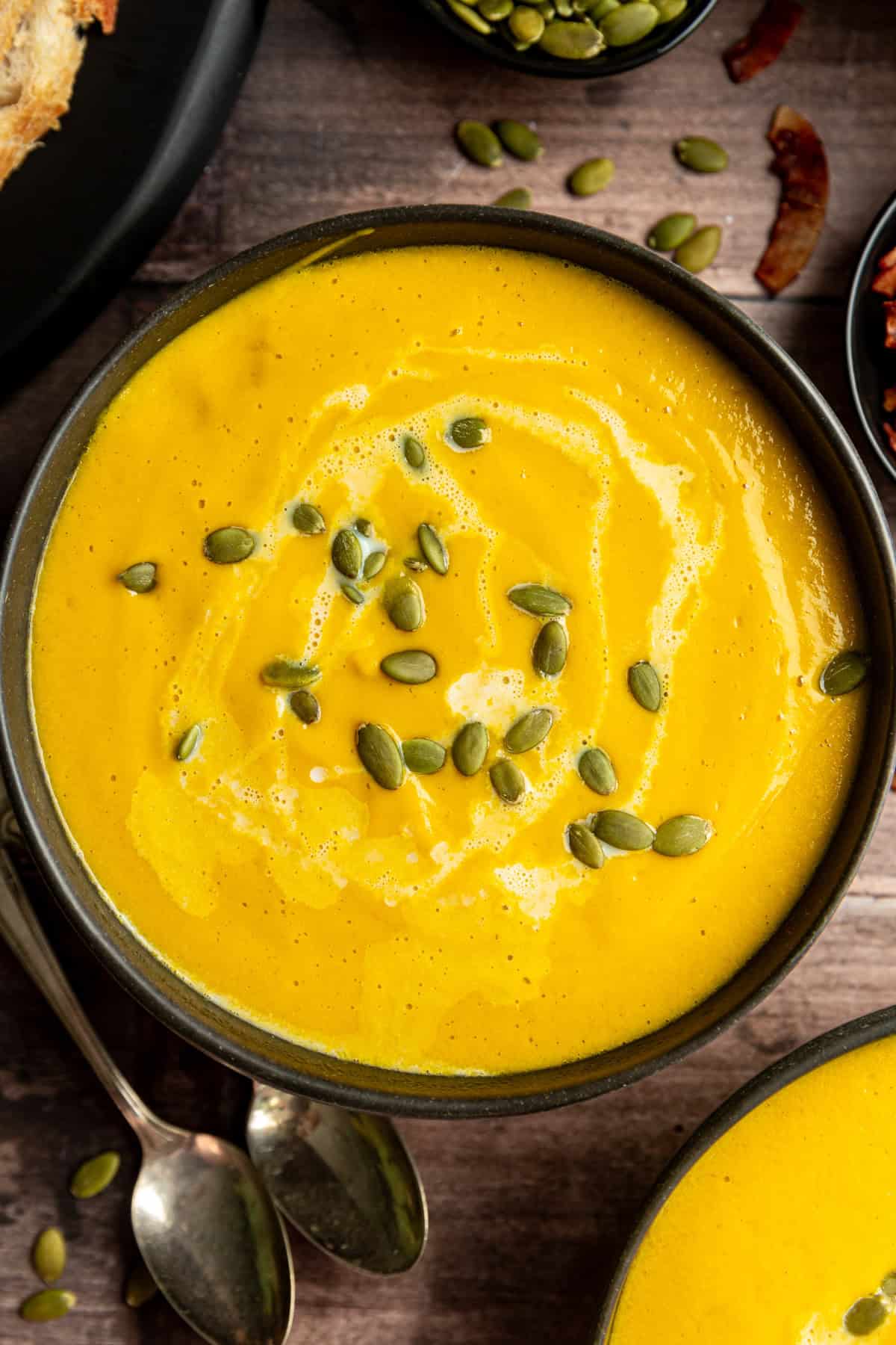 Vegan Butternut Squash Leek Soup In a bowl garnished with pumpkin seeds.