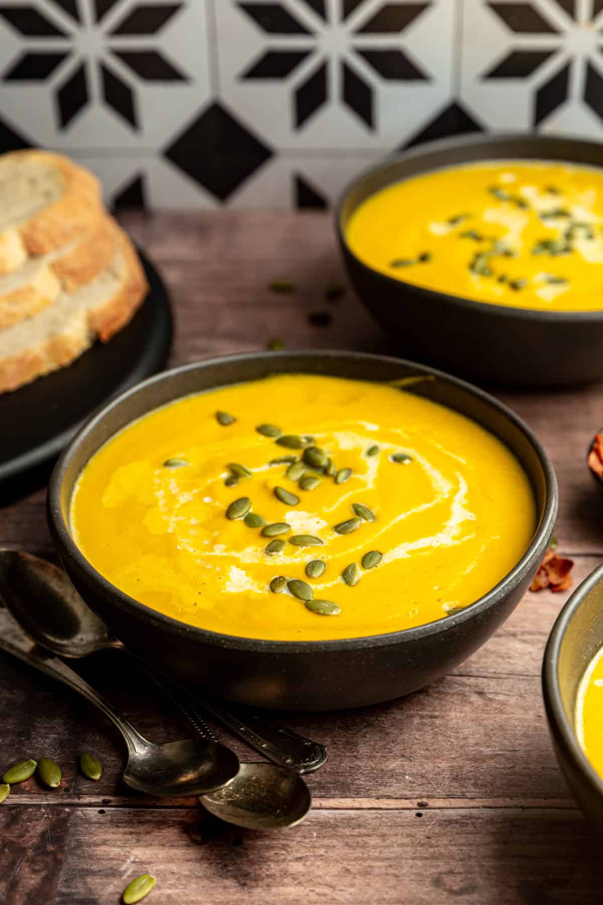 Vegan Butternut Squash Leek Soup In a bowl garnished with pumpkin seeds.