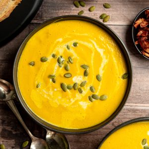 Vegan Butternut Squash Leek Soup In a bowl garnished with pumpkin seeds.