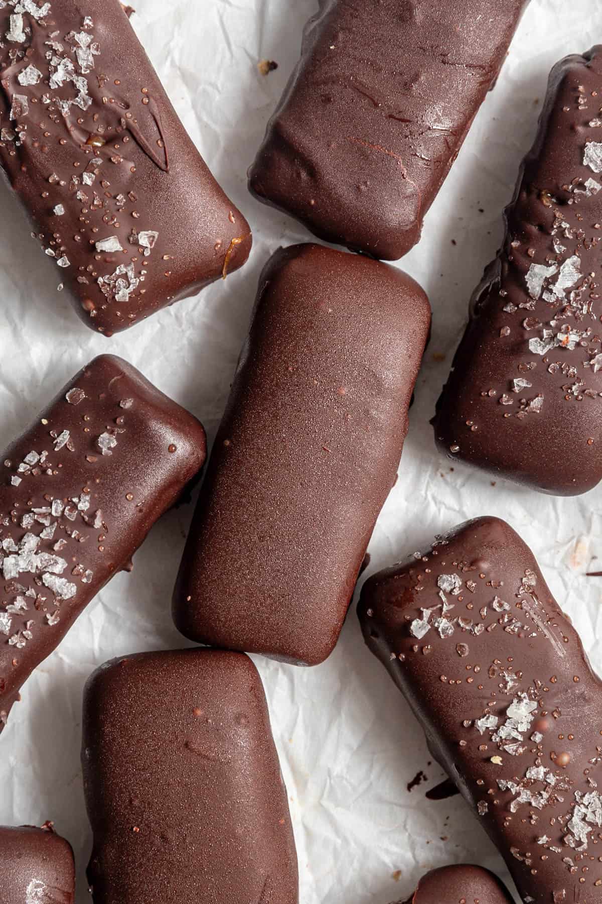 Several vegan twix bars on a sheet of parchment paper.