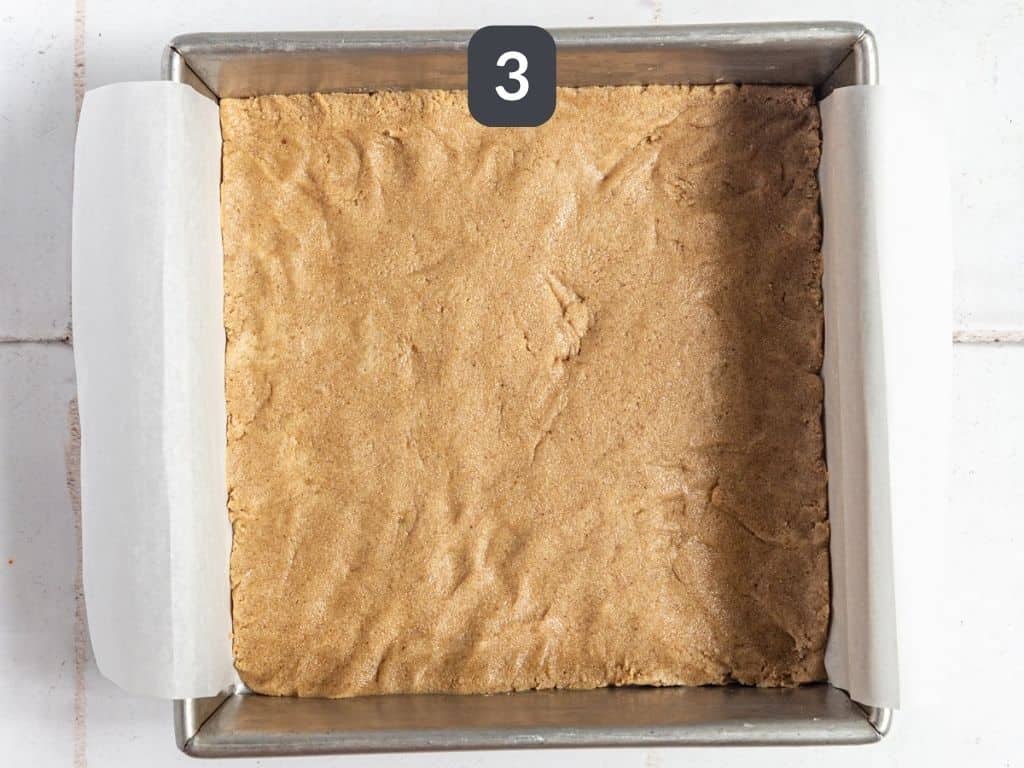 Vegan twix bars step 3 - press the cookie layer into the pan.