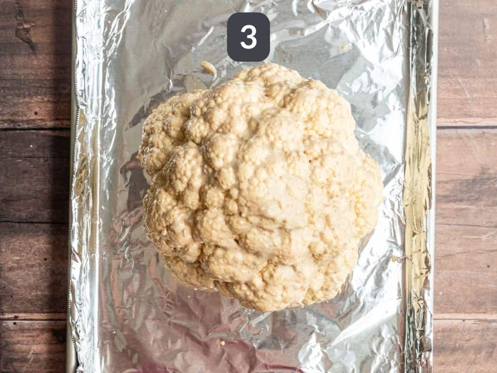 Whole Roasted Cauliflower Step 3 - brush the cauliflower with tahini sauce.