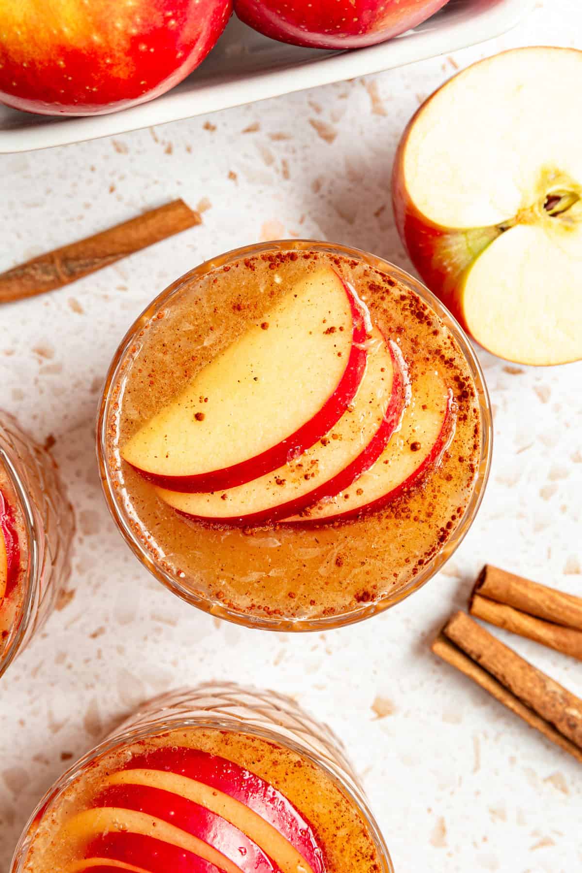 An Apple Mocktail with three apple slices.