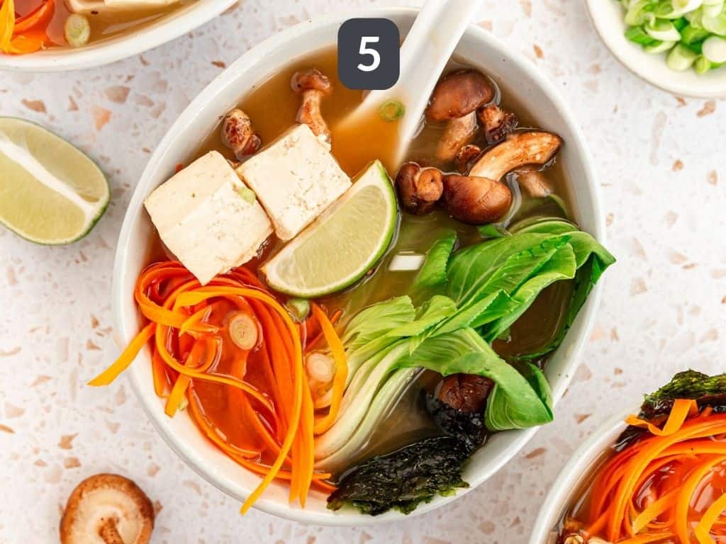Miso soup with bok choy step 5 - serve with bean sprouts, carrots, nori, and lime wedges.