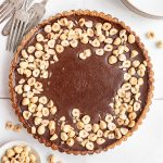 A Vegan Chocolate Hazelnut Tart fresh out of the fridge, still in the tart pan.