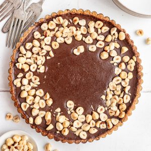 A Vegan Chocolate Hazelnut Tart fresh out of the fridge, still in the tart pan.