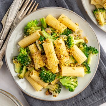 A plate of vegan pistachio pasta sauce with broccoli.