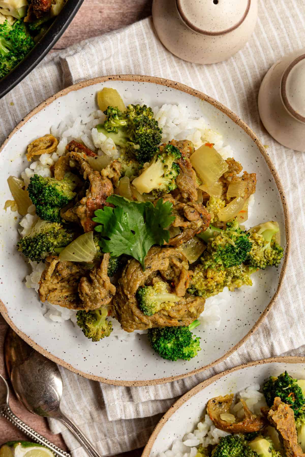 A bowl of curry on a napkin, garnished with cilantro.
