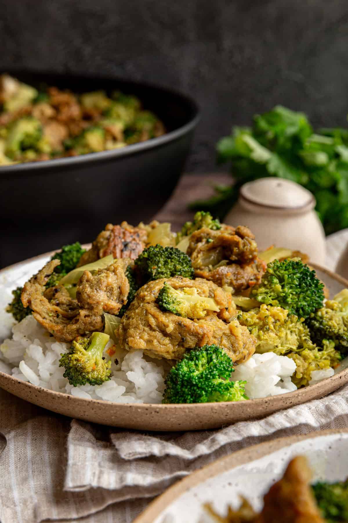 A bowl of vegan chicken curry with a large piece of seitan chicken on top.