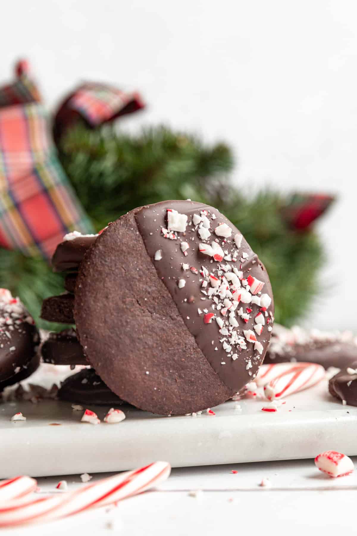 A stack of Vegan Chocolate Peppermint Cookies, with one cookie leaning on the stack.
