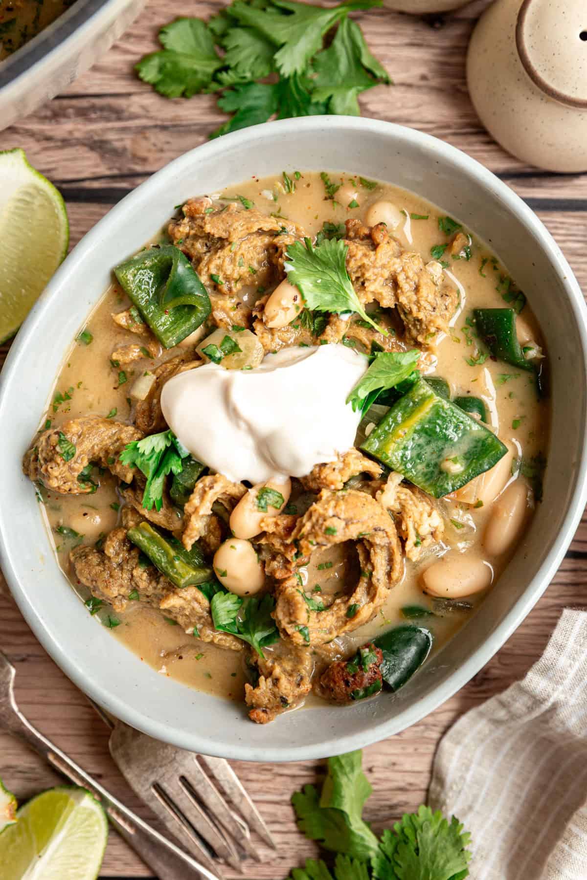 A bowl of vegan white chicken chili, served with a dollop of non-dairy yogurt.