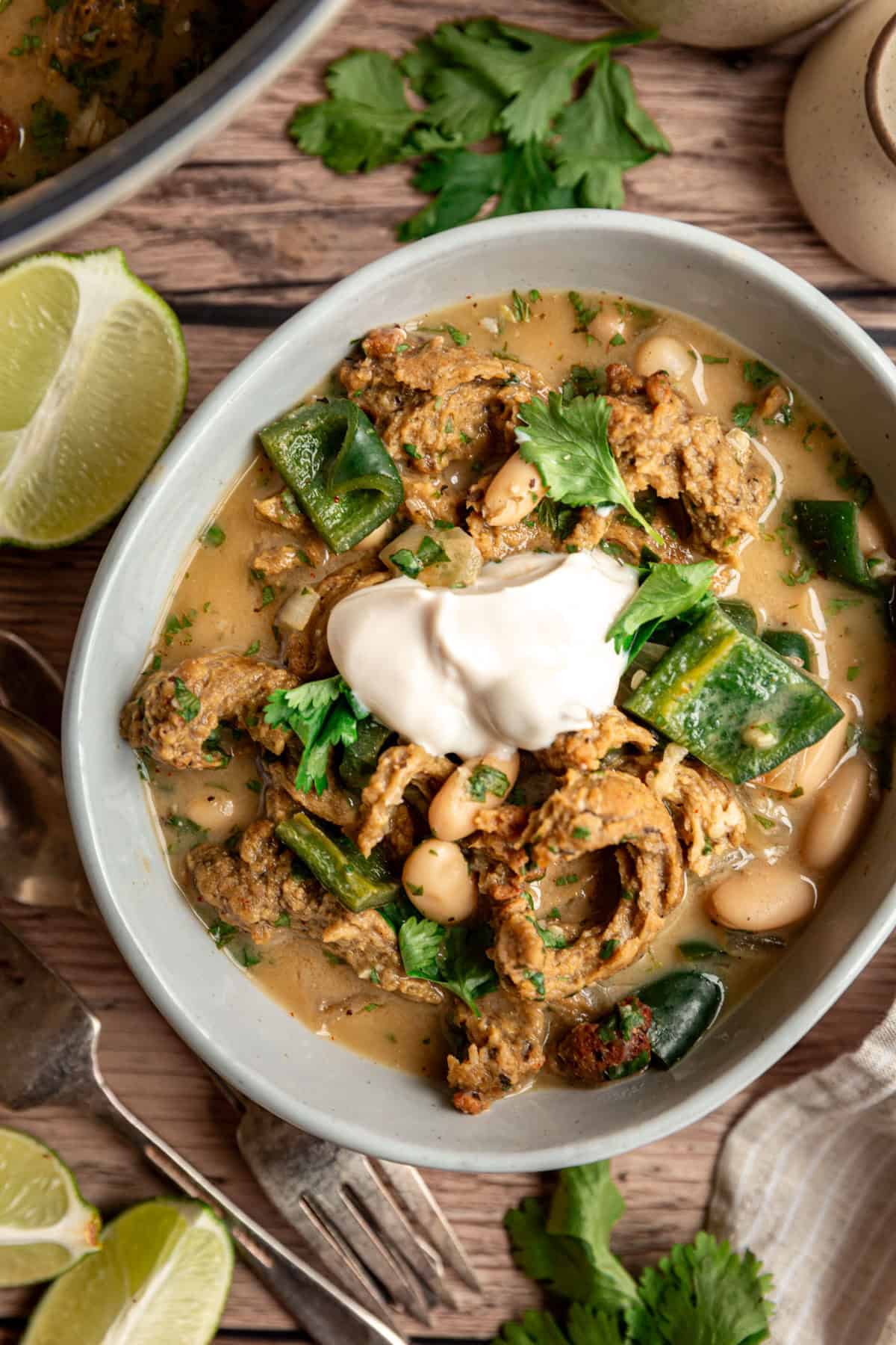 A bowl of vegan white chicken chili, served with a dollop of non-dairy yogurt.