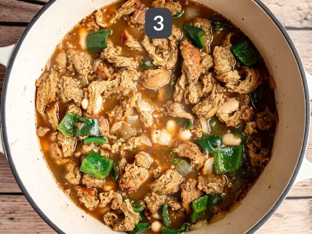 Vegan white chicken chili step 3 - add the broth, beans, and chicken.