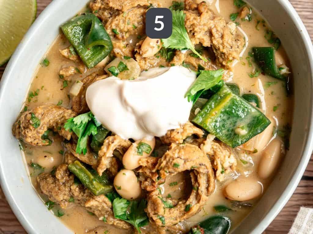 Vegan white chicken chili step 5 - serve with more cilantro and yogurt.
