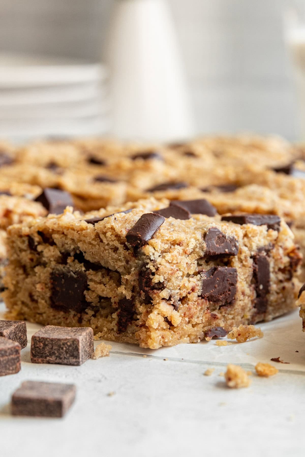 A tray of Healthy Vegan Chocolate Chip Chickpea Blondies sliced and served.