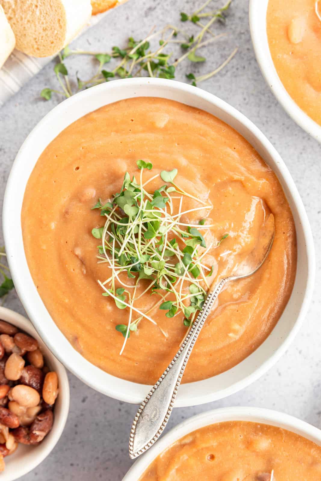 A spoon scooping Easy Vegan Pinto Bean Soup.