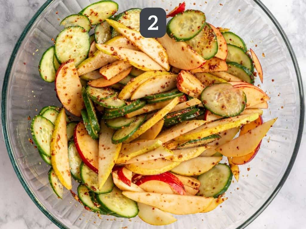 Apple Pear Cucumber Salad Step 2 - toss dressing with apples, pear, and cucumber.