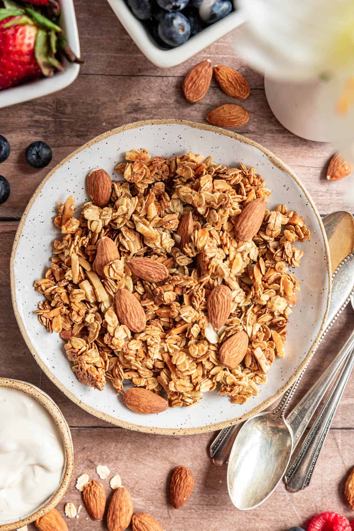 Vanilla almond granola served in a bowl with some extra almonds.