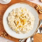 A bowl of bourbon orange rice pudding, garnished with orange zest.