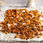 Coconut curry granola cooling on a rack.