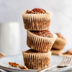 A stack of coffee pecan breakfast muffins on a plate.