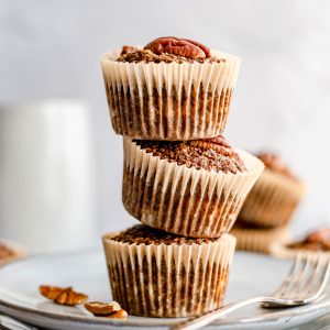 A stack of coffee pecan breakfast muffins on a plate.