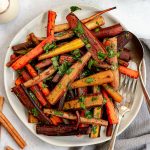 A plate of spicy roasted carrots, topped with cilantro.