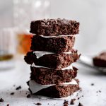 A stack of vegan bourbon brownies.