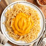 A plate of spaghetti topped with creamy sweet potato pasta sauce.