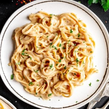 A plate of pasta tossed with vegan béchamel sauce.