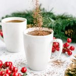 Shaved chocolate being sprinkled into a mug of healthy peppermint mocha.
