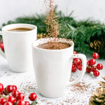 Shaved chocolate being sprinkled into a mug of healthy peppermint mocha.