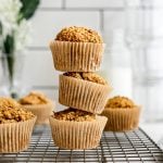 A stack of carrot cake banana muffins on a cooling rack.