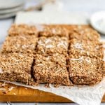 Sliced coconut pulp granola bars on a cutting board.
