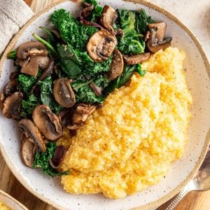 A bowl of polenta and sautéed greens.