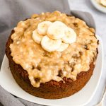 Banana cake with banana glaze, topped with banana slices.