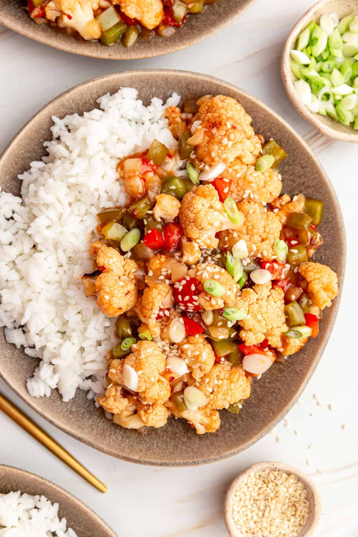 A plate of sweet and sour cauliflower and rice, ready to serve.