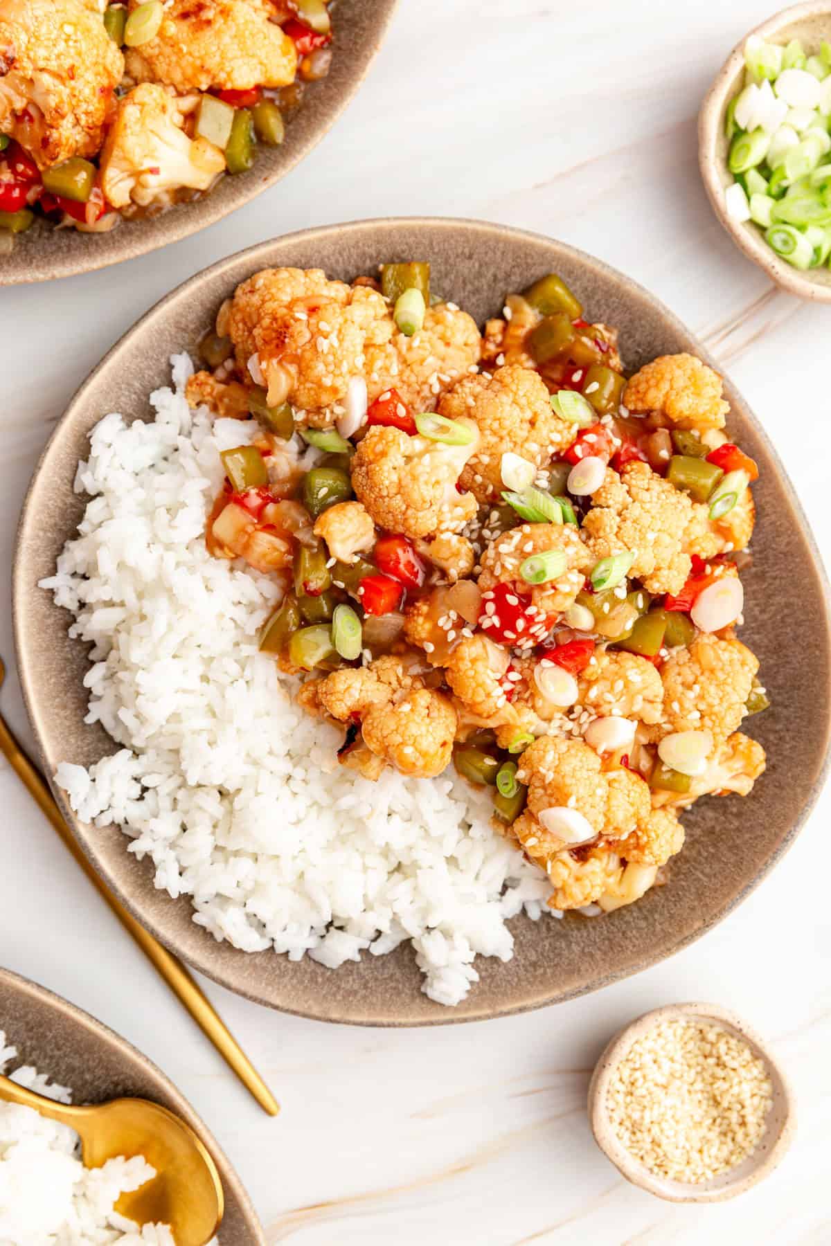 A plate of sweet and sour cauliflower served with rice.