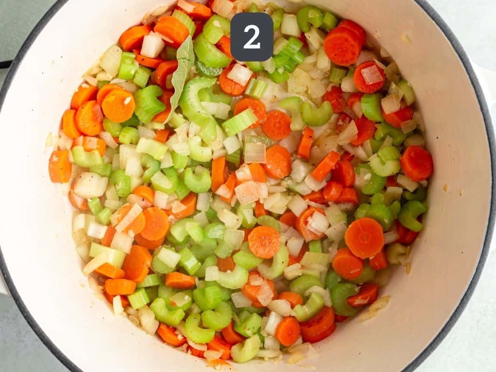 Vegan chicken noodle soup step 2 - sauté the onion, carrot, and celery.