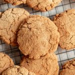 A pile of vegan gluten-free snickerdoodles on a cooling rack.