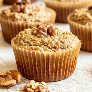 Several vegan walnut muffins on a countertop.