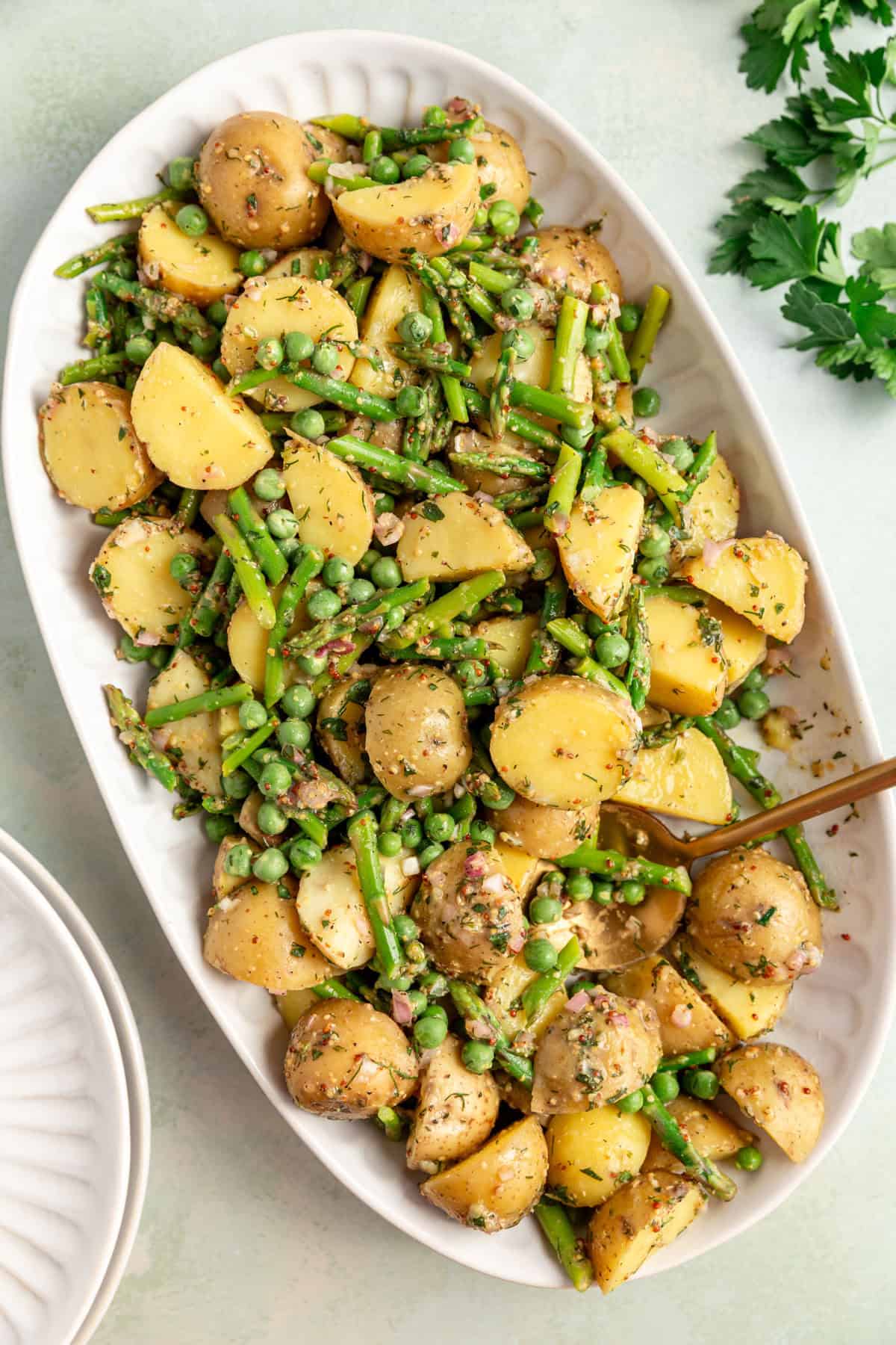 A platter of vegan potato salad, being served.